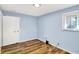 Spare bedroom with blue walls, closet, and natural light from a single window at 7133 Mc Lain Dr, Indianapolis, IN 46217