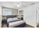 Cozy bedroom featuring a comfortable bed, soft rug, and mirrored closet doors at 7133 Mc Lain Dr, Indianapolis, IN 46217