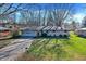 Charming brick home with attached garage, neat landscaping, and a long driveway, offering great curb appeal at 7133 Mc Lain Dr, Indianapolis, IN 46217