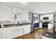 Modern kitchen featuring stainless steel appliances, a large sink, and abundant cabinetry at 7133 Mc Lain Dr, Indianapolis, IN 46217