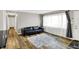Comfortable living room with wood floors, fresh paint, large window and view towards entry at 7133 Mc Lain Dr, Indianapolis, IN 46217