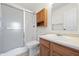 Functional bathroom with a shower, toilet, sink, and wooden cabinet at 7164 Long Shore Cir, Indianapolis, IN 46217