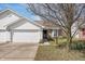 Charming single-story home featuring a two-car garage, brick accents, and a well-maintained front yard at 7164 Long Shore Cir, Indianapolis, IN 46217