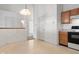 Open concept area featuring views of an adjacent kitchen with tiled floors, white walls, and light wood cabinets at 7164 Long Shore Cir, Indianapolis, IN 46217
