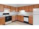 Well-lit kitchen featuring wood cabinets, ample counter space, and modern appliances against the backdrop of a tiled floor at 7164 Long Shore Cir, Indianapolis, IN 46217