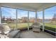 Relaxing screened porch features wicker seating and a peaceful view of the outside at 7164 Long Shore Cir, Indianapolis, IN 46217