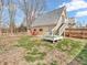 Backyard featuring an elevated deck area with a stairway, partial grass, and landscaping at 7540 S Mooresville Rd, Indianapolis, IN 46221