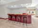 Close up of the large bar with barstools in the carpeted bonus room at 7540 S Mooresville Rd, Indianapolis, IN 46221