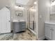 Bathroom with tiled floors and shower surround, gray vanity, and updated fixtures at 7540 S Mooresville Rd, Indianapolis, IN 46221