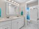 Bright bathroom featuring a double vanity with a large mirror, and shower at 7540 S Mooresville Rd, Indianapolis, IN 46221