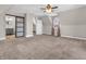 Bedroom showcasing neutral walls, carpet, a window, an ensuite bathroom and access to another room at 7540 S Mooresville Rd, Indianapolis, IN 46221