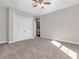 Bedroom with neutral carpet, double closet and light wood ceiling fan at 7540 S Mooresville Rd, Indianapolis, IN 46221