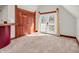 Bonus room with neutral walls and carpet, closet with barn door, and access to an outdoor deck at 7540 S Mooresville Rd, Indianapolis, IN 46221