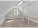 Bonus room featuring neutral carpet, built in shelving, and a single window at 7540 S Mooresville Rd, Indianapolis, IN 46221