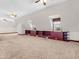 Large, carpeted bonus room with built-ins, natural light and ceiling fans at 7540 S Mooresville Rd, Indianapolis, IN 46221