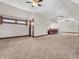 Spacious carpeted bonus room with bar, ceiling fans and natural light at 7540 S Mooresville Rd, Indianapolis, IN 46221
