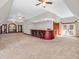 Expansive carpeted bonus room featuring a large bar and natural light at 7540 S Mooresville Rd, Indianapolis, IN 46221