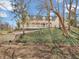 Charming yellow home with a welcoming white porch and decorative bunting, nestled among mature trees and greenery at 7540 S Mooresville Rd, Indianapolis, IN 46221