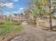 Inviting two-story yellow home with detached garage surrounded by mature trees and green lawn at 7540 S Mooresville Rd, Indianapolis, IN 46221