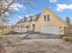Yellow two-story home with attached garage and long porch, highlighted by a well-paved driveway at 7540 S Mooresville Rd, Indianapolis, IN 46221
