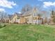 Charming yellow home featuring a welcoming front porch, landscaped lawn, and well-maintained exterior at 7540 S Mooresville Rd, Indianapolis, IN 46221