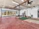 Spacious garage interior, featuring an open layout with a functional ceiling fan, and convenient side door at 7540 S Mooresville Rd, Indianapolis, IN 46221