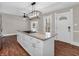 Kitchen island with granite countertop, cooktop and storage at 7540 S Mooresville Rd, Indianapolis, IN 46221