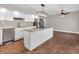 Open concept kitchen with a large island, stainless appliances, and wood flooring at 7540 S Mooresville Rd, Indianapolis, IN 46221