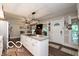 Open kitchen and dining area featuring an island with white cabinetry, granite countertops, and pendant lighting at 7540 S Mooresville Rd, Indianapolis, IN 46221