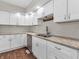 Kitchen with white cabinets, granite countertops, and stainless steel appliances at 7540 S Mooresville Rd, Indianapolis, IN 46221