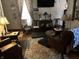Cozy living room with hardwood floors, traditional furniture, and decorative lamps at 7540 S Mooresville Rd, Indianapolis, IN 46221