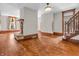Spacious living room featuring hardwood floors, a stone fireplace, and natural light at 7540 S Mooresville Rd, Indianapolis, IN 46221