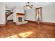 Spacious living room featuring hardwood floors, a stone fireplace, and a view of the stairs to the second floor at 7540 S Mooresville Rd, Indianapolis, IN 46221