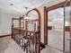 Staircase landing with arched doorway and trim looking into the bonus room at 7540 S Mooresville Rd, Indianapolis, IN 46221