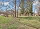 Expansive green yard with mature trees, offering ample space and a serene outdoor setting at 7540 S Mooresville Rd, Indianapolis, IN 46221
