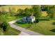 Aerial view of a gray two-story home featuring mature trees, and a basketball hoop at 7845 W Hillside Dr, Columbus, IN 47201