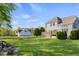 Expansive backyard with a well-maintained lawn, mature trees, deck, and ample space for outdoor activities at 7845 W Hillside Dr, Columbus, IN 47201
