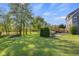 Spacious backyard with mature trees, a swing set, a patio with outdoor seating, and a deck at 7845 W Hillside Dr, Columbus, IN 47201