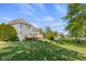 Spacious backyard featuring lush greenery, a wooden deck, providing a serene outdoor retreat at 7845 W Hillside Dr, Columbus, IN 47201