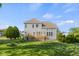 Back exterior view of a gray house with a wooden deck at 7845 W Hillside Dr, Columbus, IN 47201