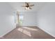 This spacious bedroom has carpet, a ceiling fan, and two windows at 7845 W Hillside Dr, Columbus, IN 47201