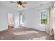 Carpeted bedroom with ceiling fan with en suite bath at 7845 W Hillside Dr, Columbus, IN 47201