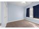 This carpeted bedroom has a ceiling fan, closet and natural light at 7845 W Hillside Dr, Columbus, IN 47201