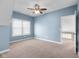 Bedroom featuring carpeted floors, ceiling fan, and bright light at 7845 W Hillside Dr, Columbus, IN 47201