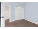 This light blue bedroom features a double closet and an open doorway at 7845 W Hillside Dr, Columbus, IN 47201