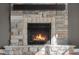 Close-up of the stone fireplace with a wooden mantle and a gas insert at 7845 W Hillside Dr, Columbus, IN 47201