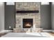 Close-up view of a stone fireplace with dark wood mantle at 7845 W Hillside Dr, Columbus, IN 47201