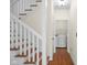 Hallway with stairs and access to the laundry room at 7845 W Hillside Dr, Columbus, IN 47201