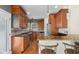 This kitchen features wooden cabinets, stainless steel appliances, tile backsplash, and a granite countertop island at 7845 W Hillside Dr, Columbus, IN 47201