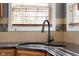 Close up of a stainless steel kitchen sink with a black faucet and tile backsplash at 7845 W Hillside Dr, Columbus, IN 47201